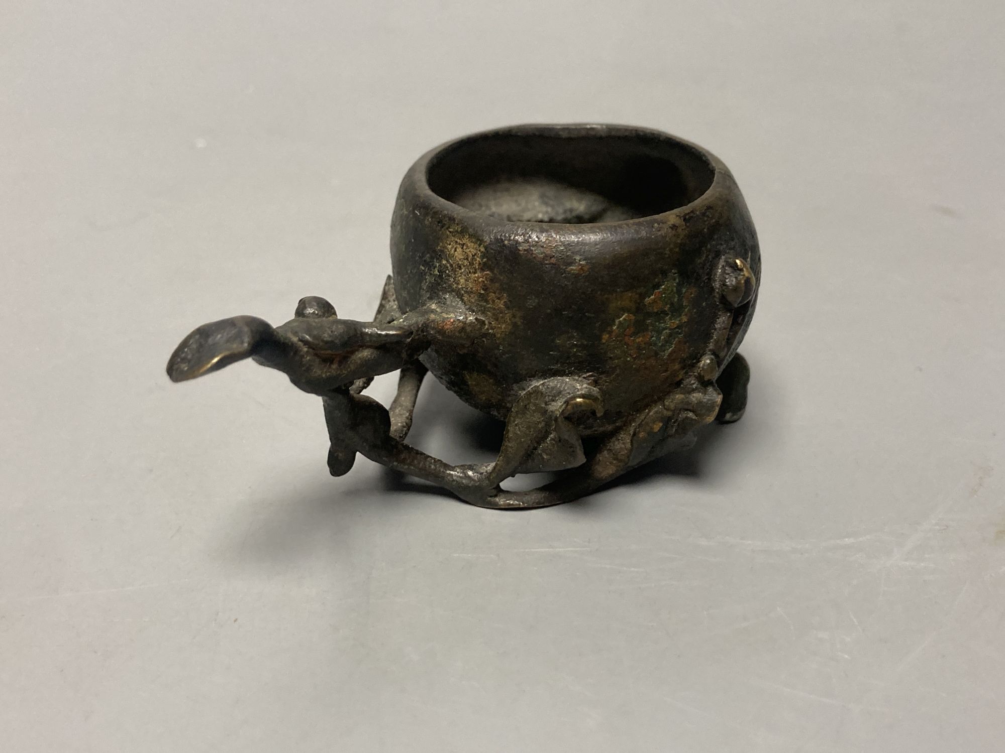 A Chinese Ming bronze peach shaped brush washer, length 9cm